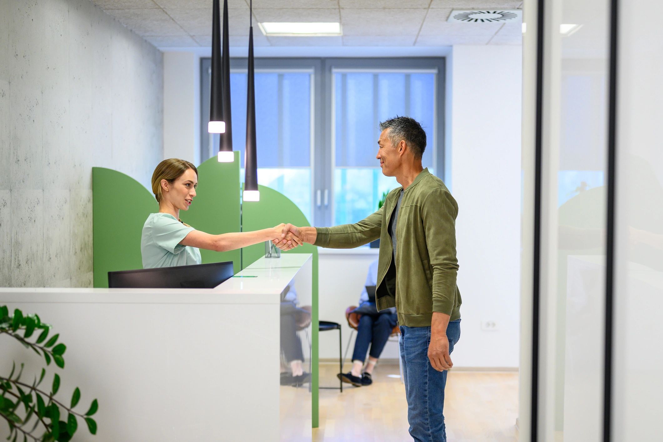 Healthcare professional greeting a patient in a modern clinic