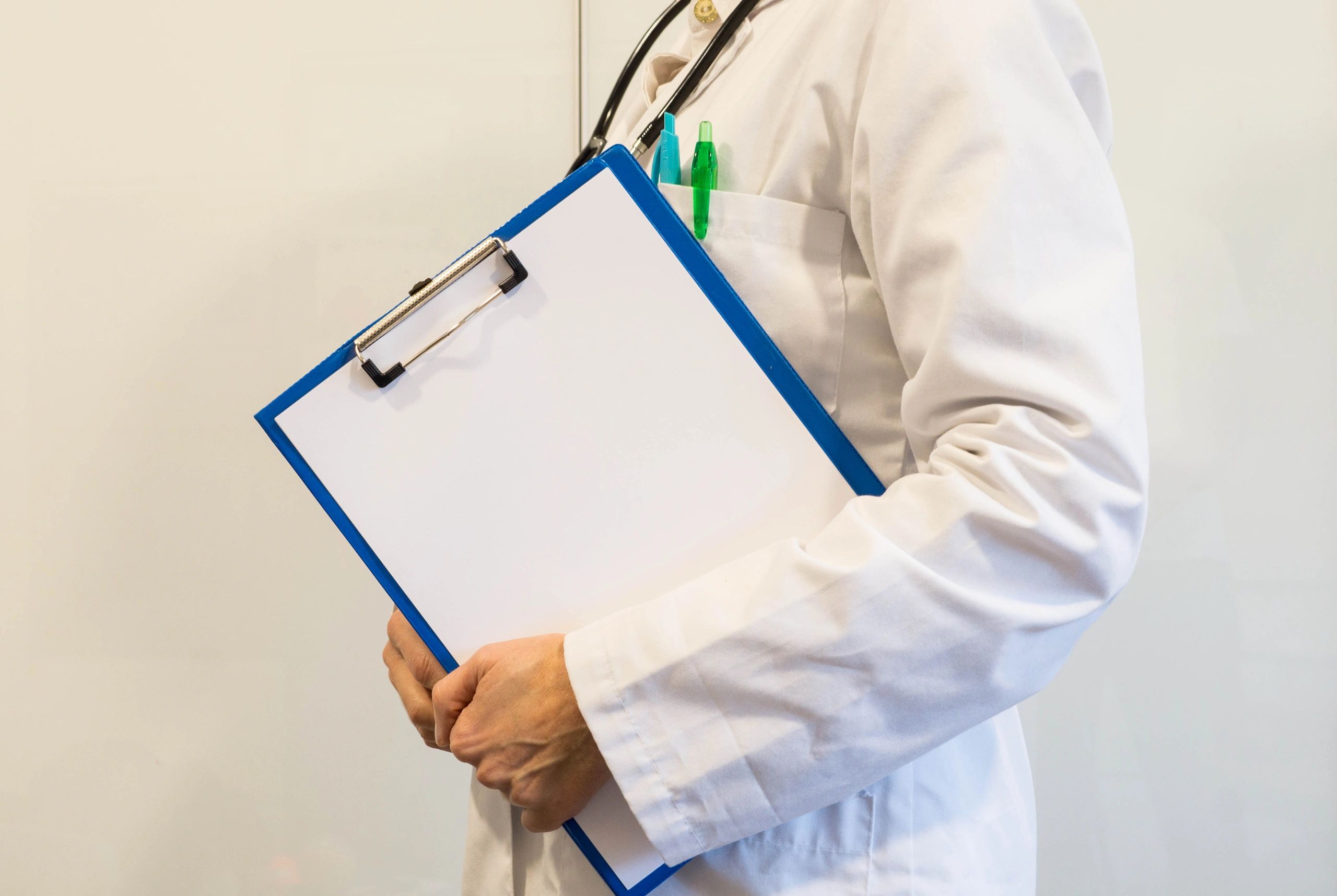 Medical professional holding a clipboard for wellness intake