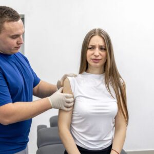 Physiotherapist examines female patient shoulder and checks joint pain. Shoulder assessment.