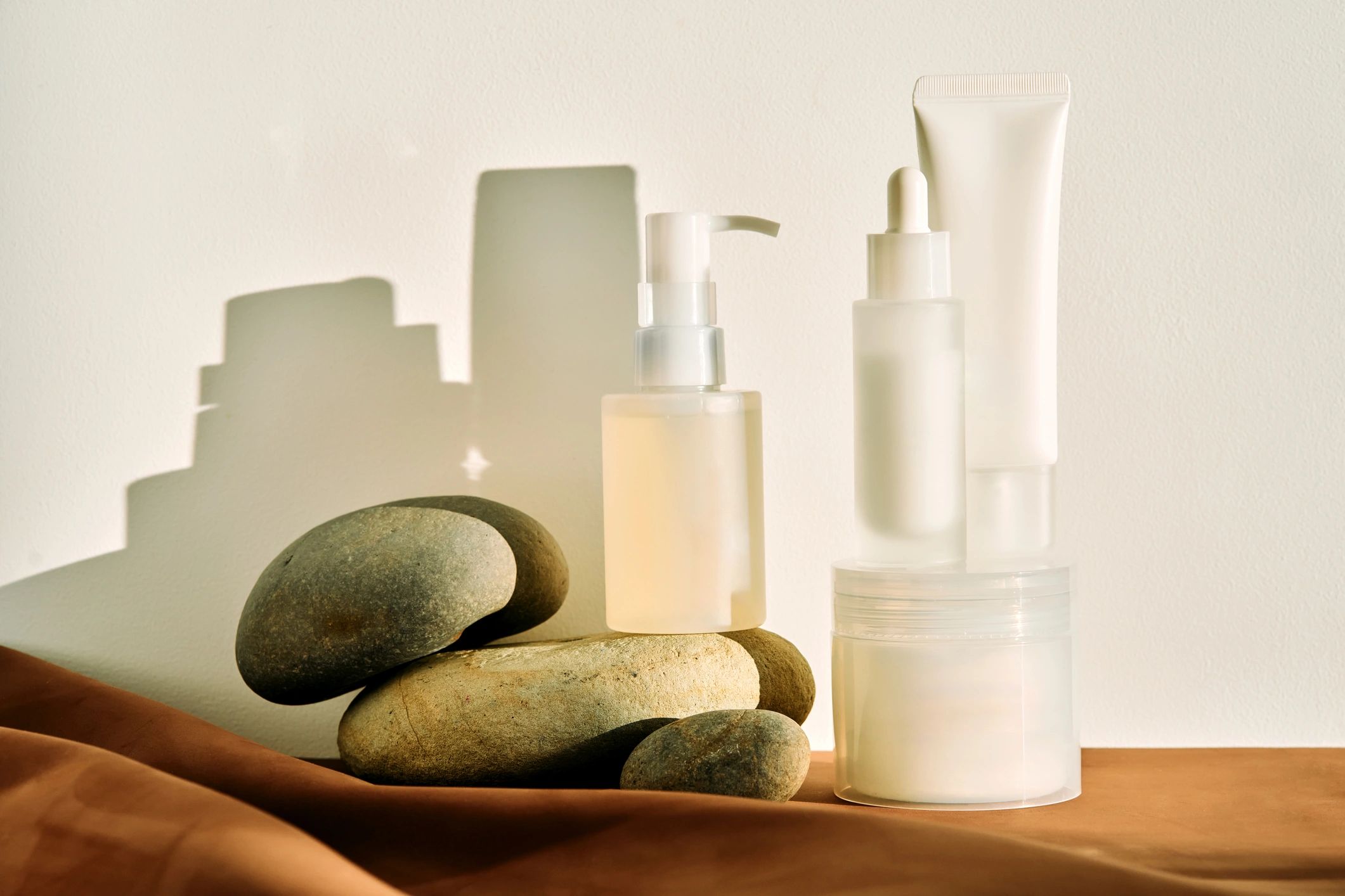 Skincare products with natural stones and shadows